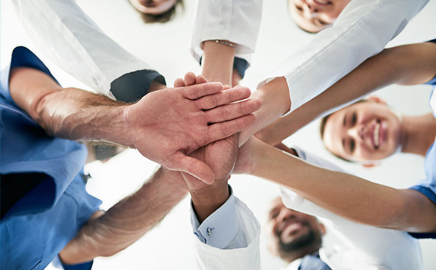 Health professionals putting hands together